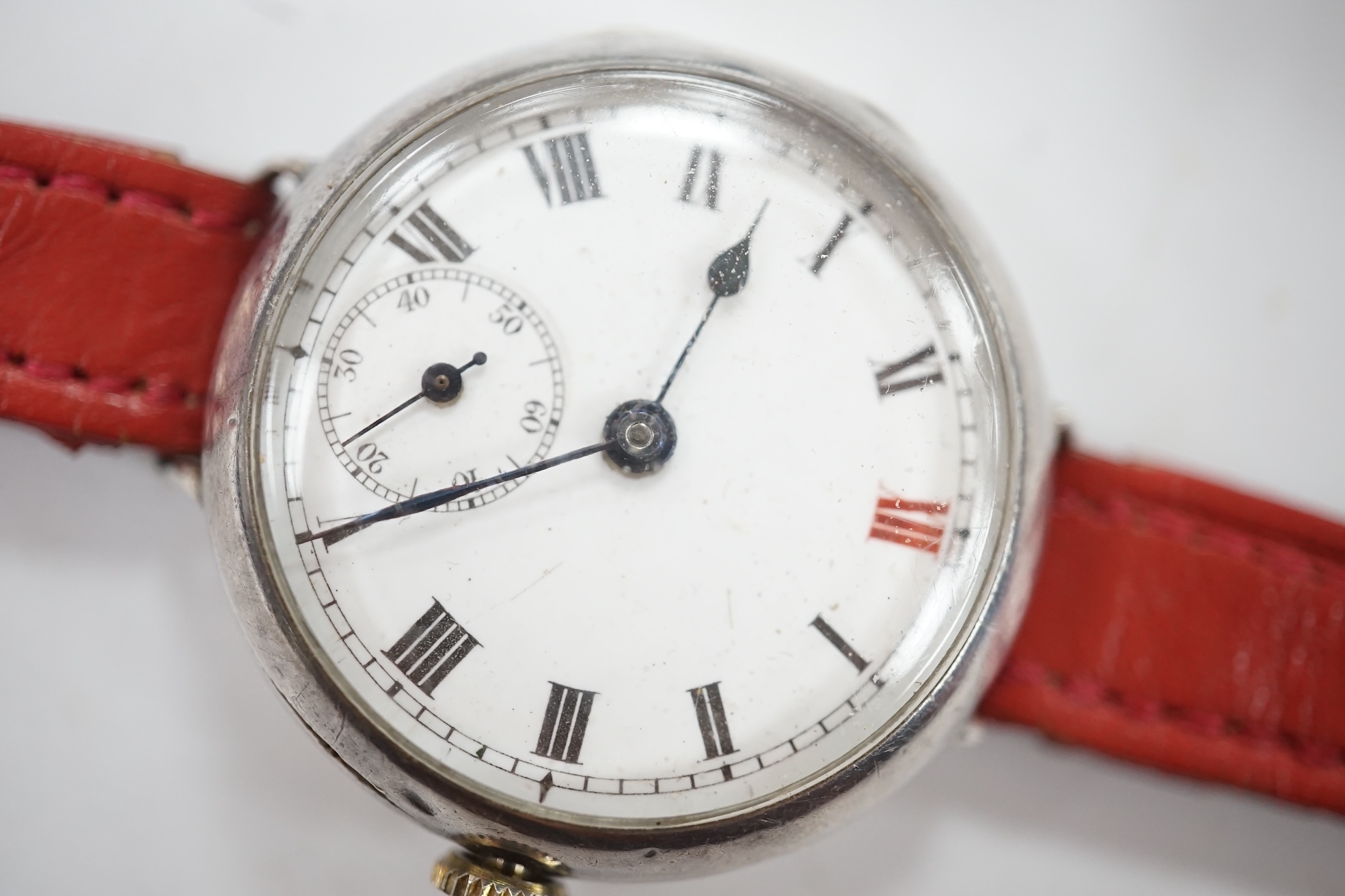 A George V 9ct gold manual wind wrist watch, with Roman dial, case diameter 27mm and a similar silver manual wind wrist watch. Condition - poor to fair